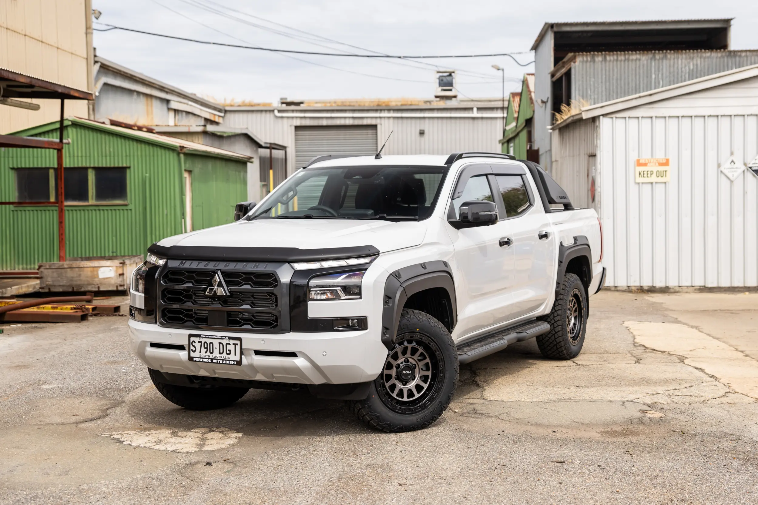 Mitsubishi Triton MV GSR with ROH Assault Graphite Centre Black Lip 4x4 Wheel in industrial area