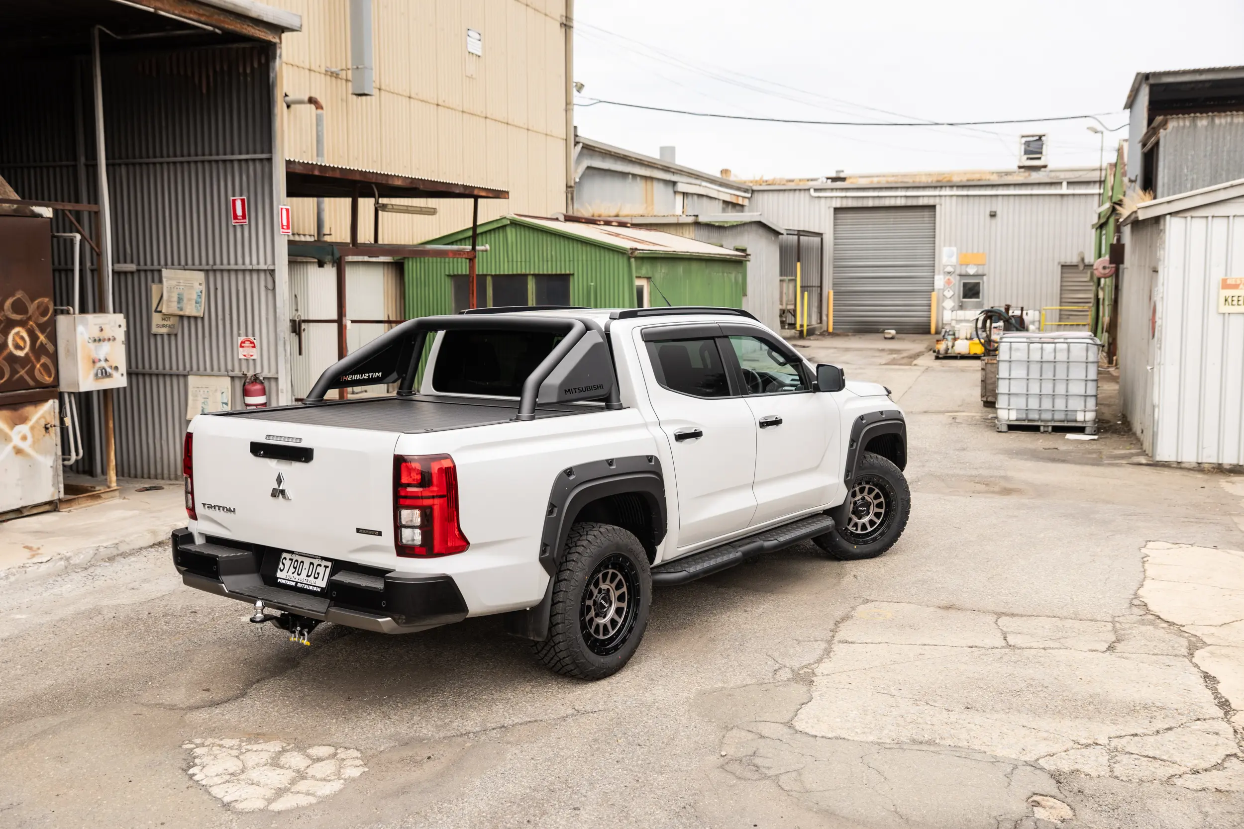Mitsubishi Triton MV GSR with ROH Assault Graphite Centre Black Lip 4x4 Wheel in industrial area