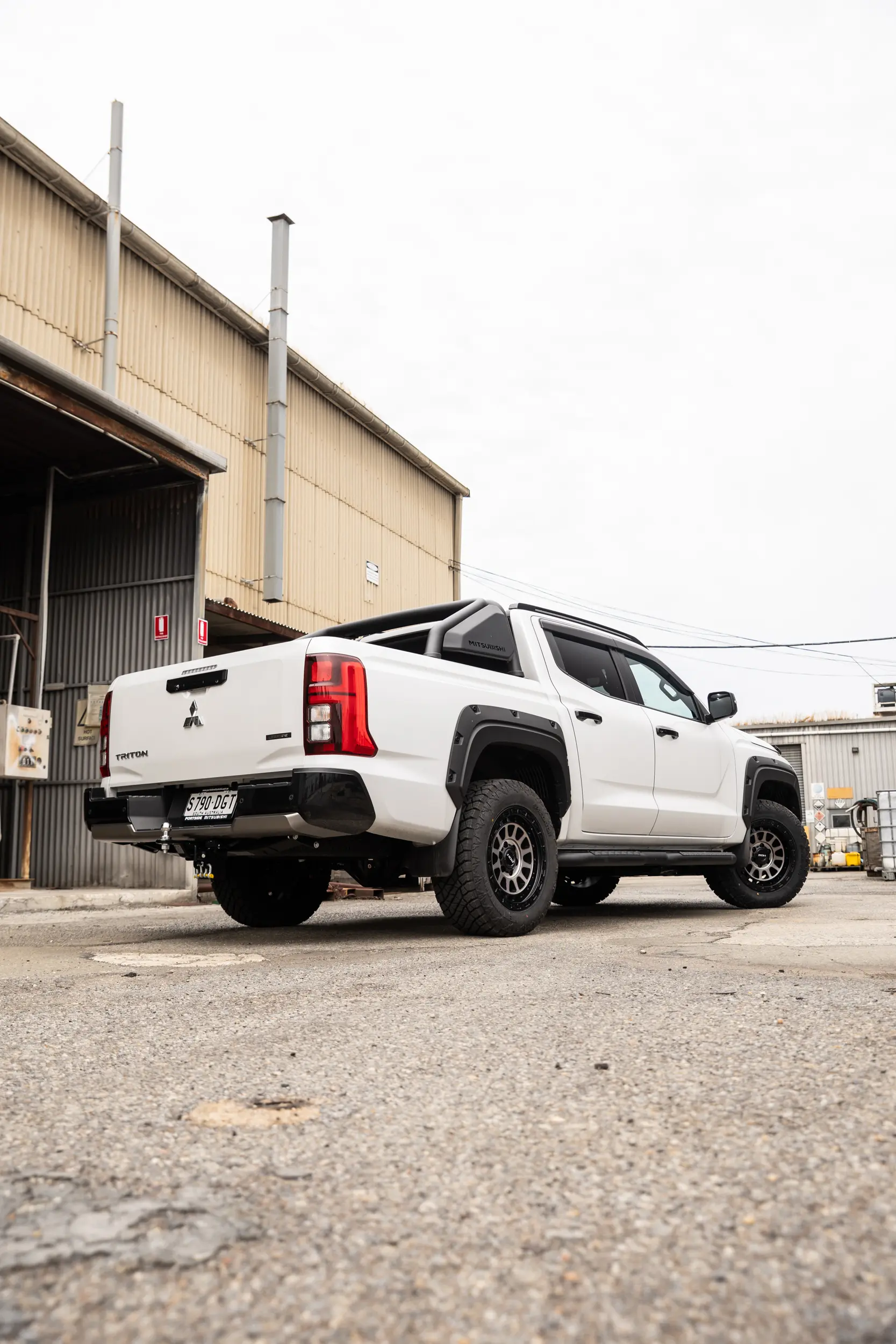 Mitsubishi Triton MV GSR with ROH Assault Graphite Centre Black Lip 4x4 Wheel in industrial area