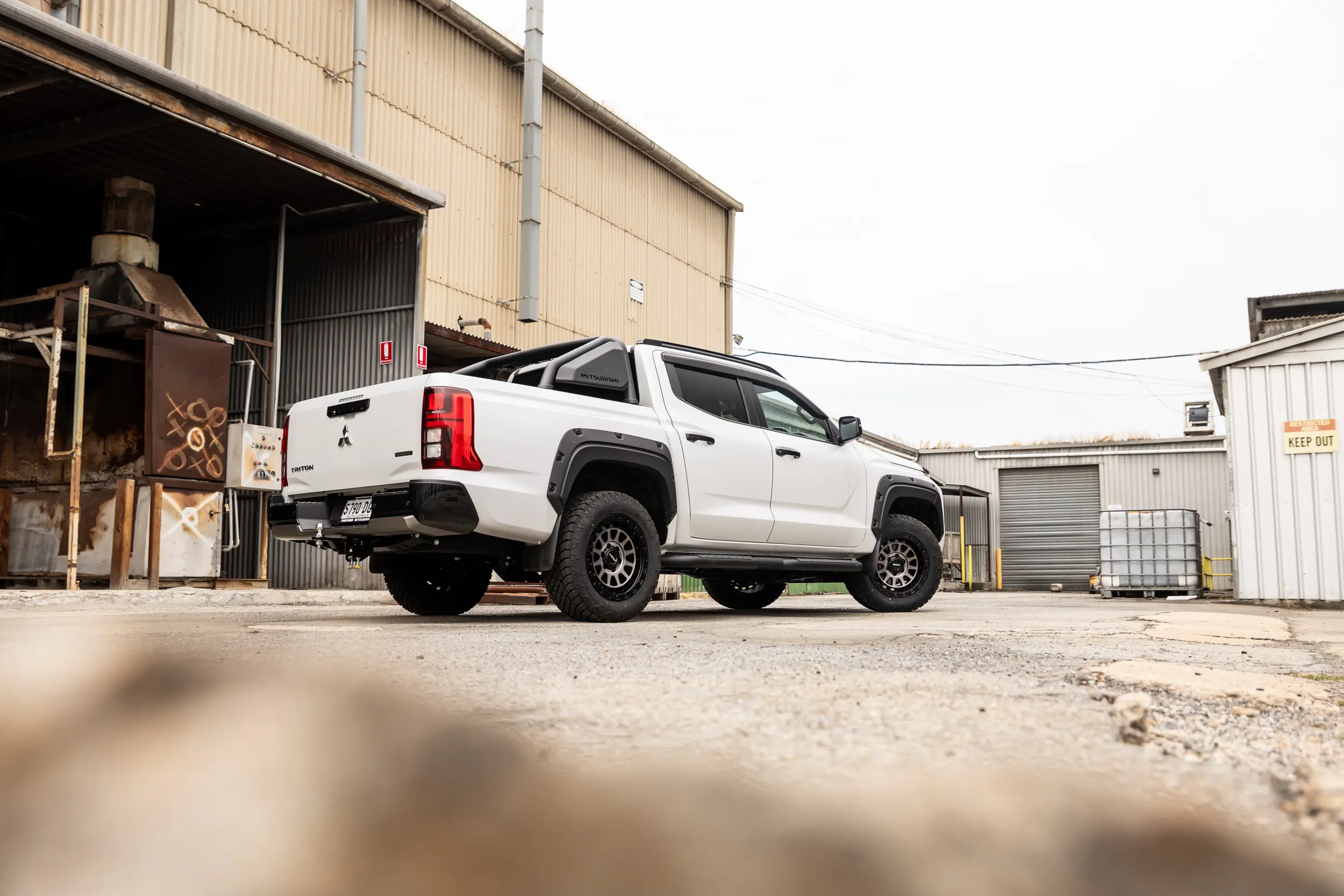 Mitsubishi Triton MV GSR with ROH Assault Graphite Centre Black Lip 4x4 Wheel in industrial area