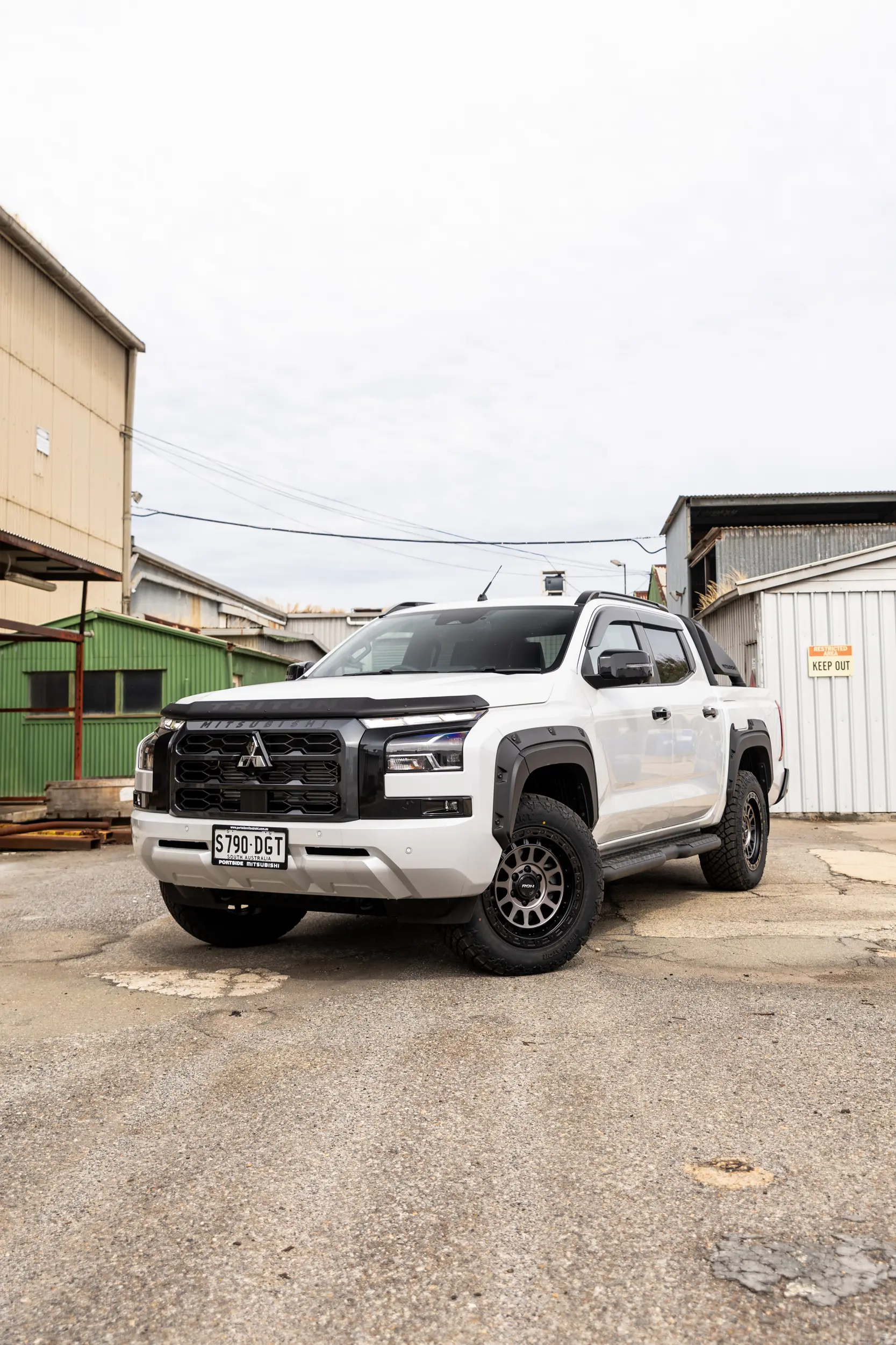 Mitsubishi Triton MV GSR with ROH Assault Graphite Centre Black Lip 4x4 Wheel in industrial area