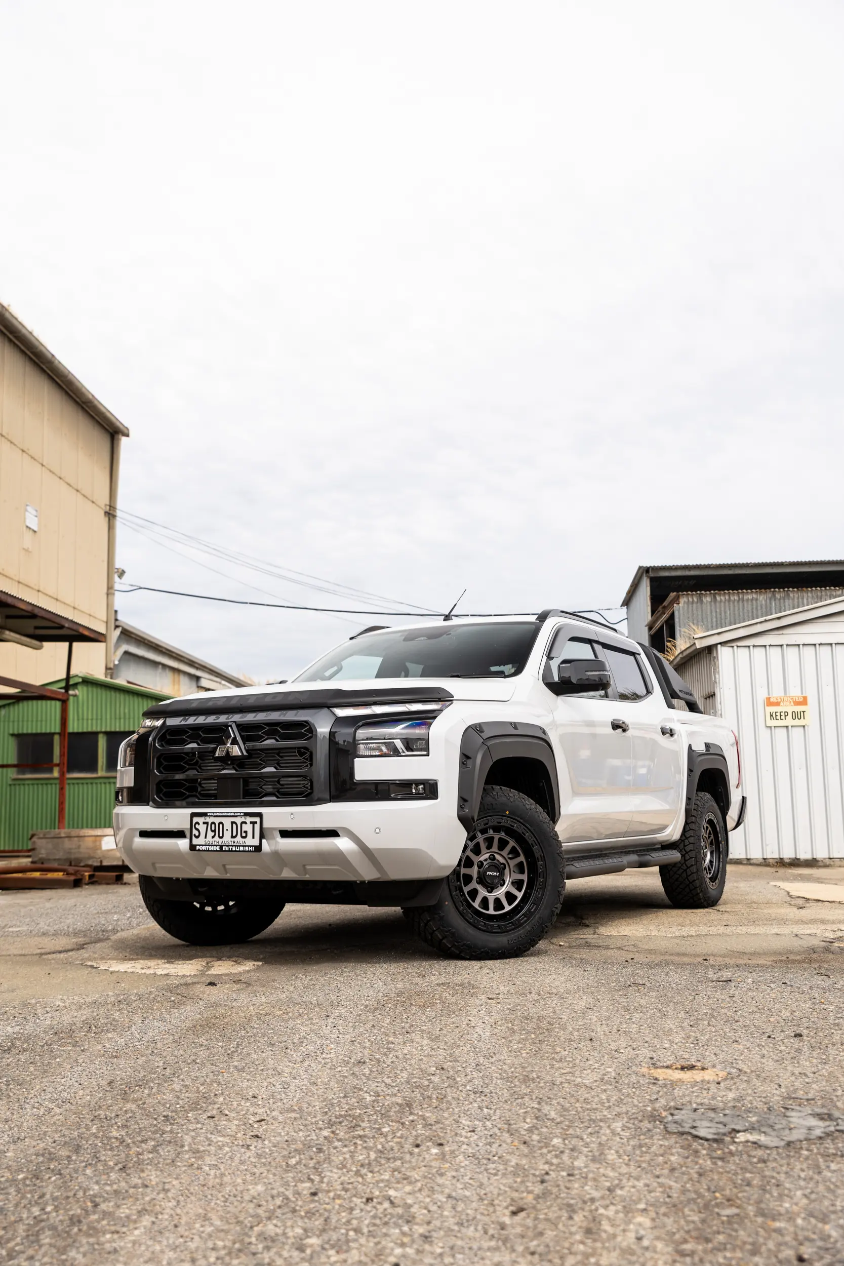 Mitsubishi Triton MV GSR with ROH Assault Graphite Centre Black Lip 4x4 Wheel in industrial area