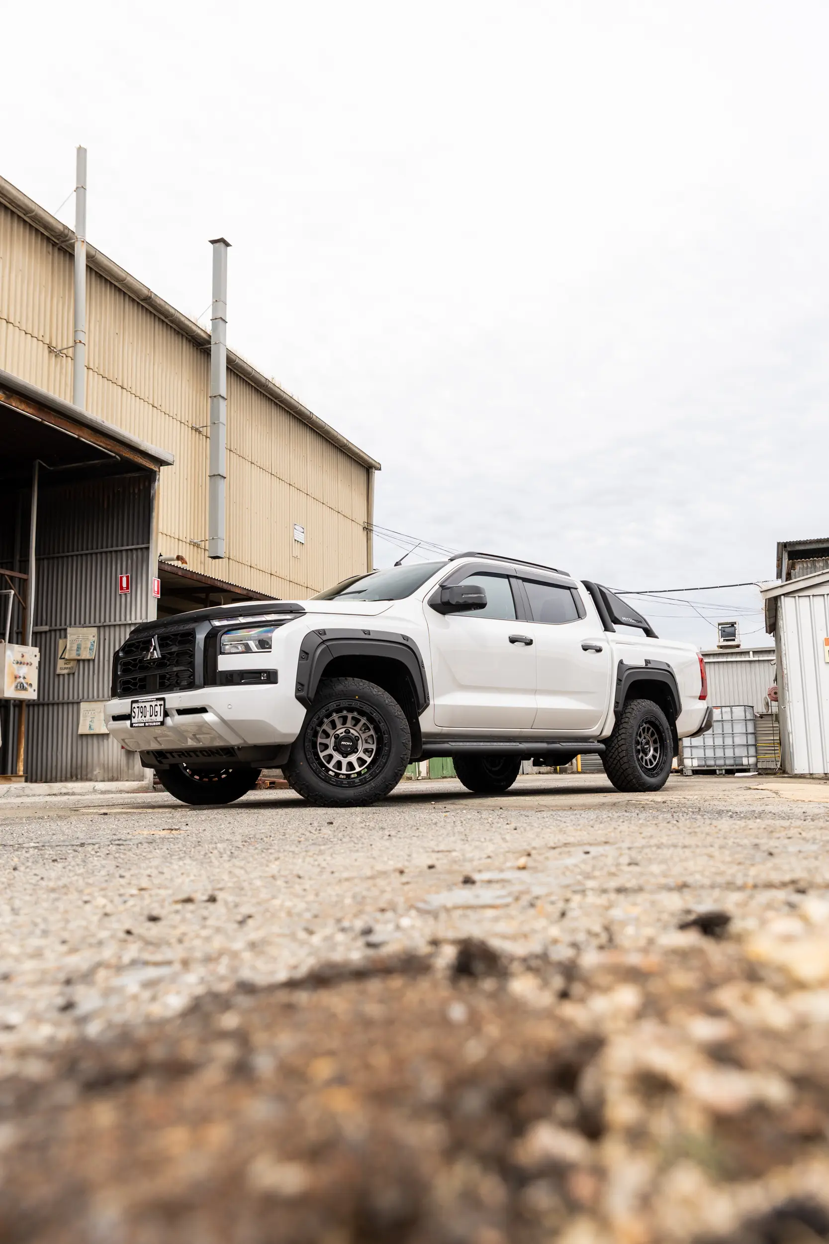 Mitsubishi Triton MV GSR with ROH Assault Graphite Centre Black Lip 4x4 Wheel in industrial area