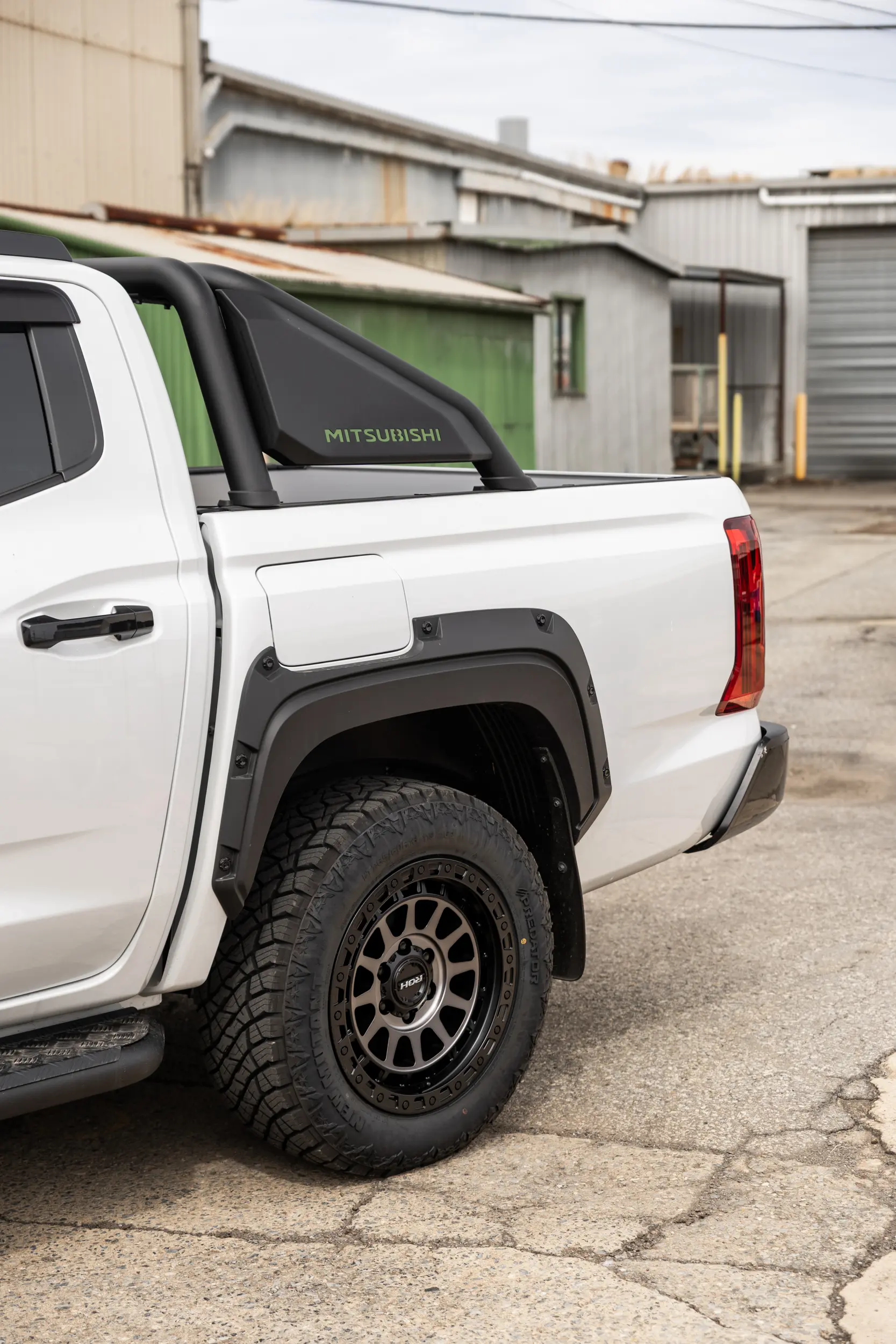 Mitsubishi Triton MV GSR with ROH Assault Graphite Centre Black Lip 4x4 Wheel in industrial area