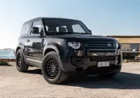 Black Land Rover Defender 90 with 20x9 +22 5x120 Matte Black ROH Assault Wheels at dockyard