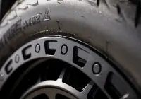 Black Land Rover Defender 90 with 20x9 +22 5x120 Matte Black ROH Assault Wheels at dockyard