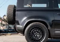 Black Land Rover Defender 90 with 20x9 +22 5x120 Matte Black ROH Assault Wheels at dockyard