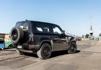 Black Land Rover Defender 90 with 20x9 +22 5x120 Matte Black ROH Assault Wheels at dockyard