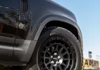 Black Land Rover Defender 90 with 20x9 +22 5x120 Matte Black ROH Assault Wheels at dockyard
