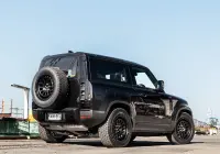Black Land Rover Defender 90 with 20x9 +22 5x120 Matte Black ROH Assault Wheels at dockyard