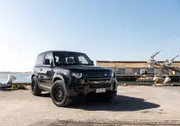 Black Land Rover Defender 90 with 20x9 +22 5x120 Matte Black ROH Assault Wheels at dockyard