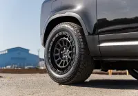 Black Land Rover Defender 90 with 20x9 +22 5x120 Matte Black ROH Assault Wheels at dockyard