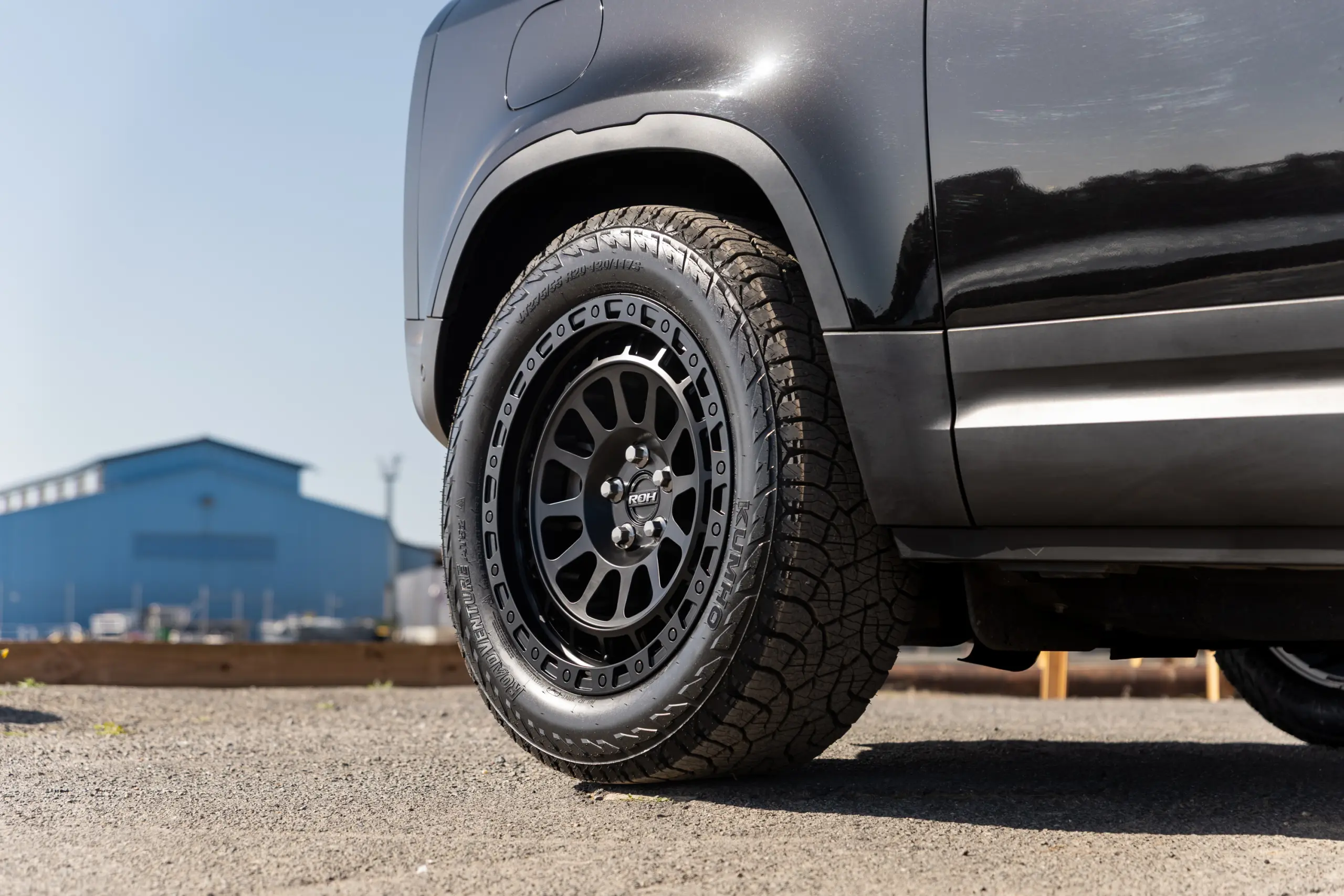 Black Land Rover Defender 90 with 20x9 +22 5x120 Matte Black ROH Assault Wheels at dockyard