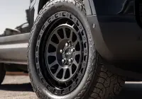 Black Land Rover Defender 90 with 20x9 +22 5x120 Matte Black ROH Assault Wheels at dockyard