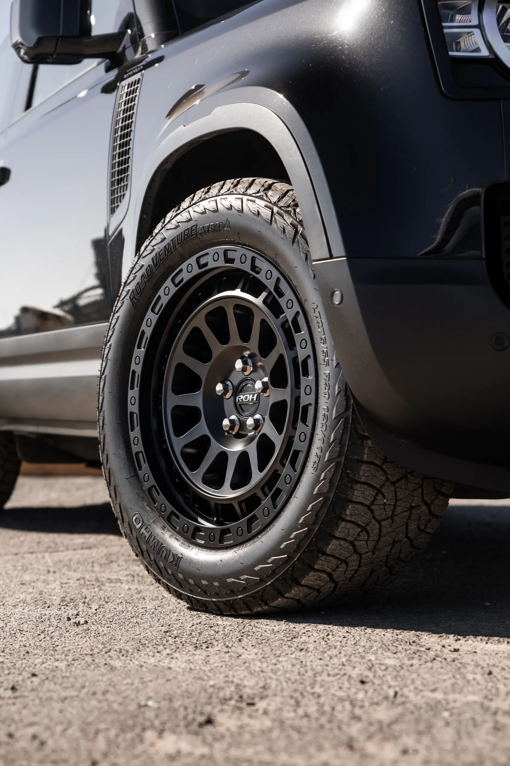 Black Land Rover Defender 90 with 20x9 +22 5x120 Matte Black ROH Assault Wheels at dockyard