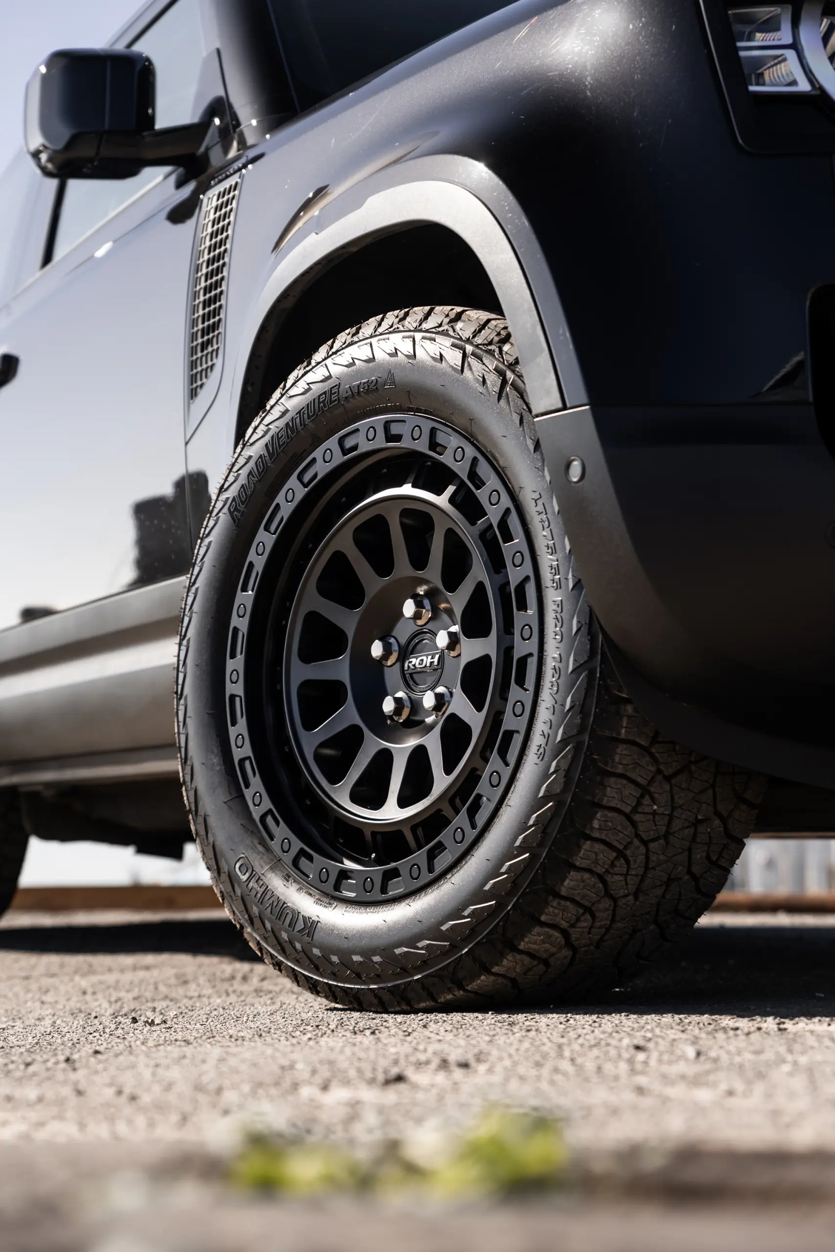 Black Land Rover Defender 90 with 20x9 +22 5x120 Matte Black ROH Assault Wheels at dockyard