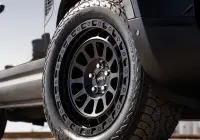 Black Land Rover Defender 90 with 20x9 +22 5x120 Matte Black ROH Assault Wheels at dockyard