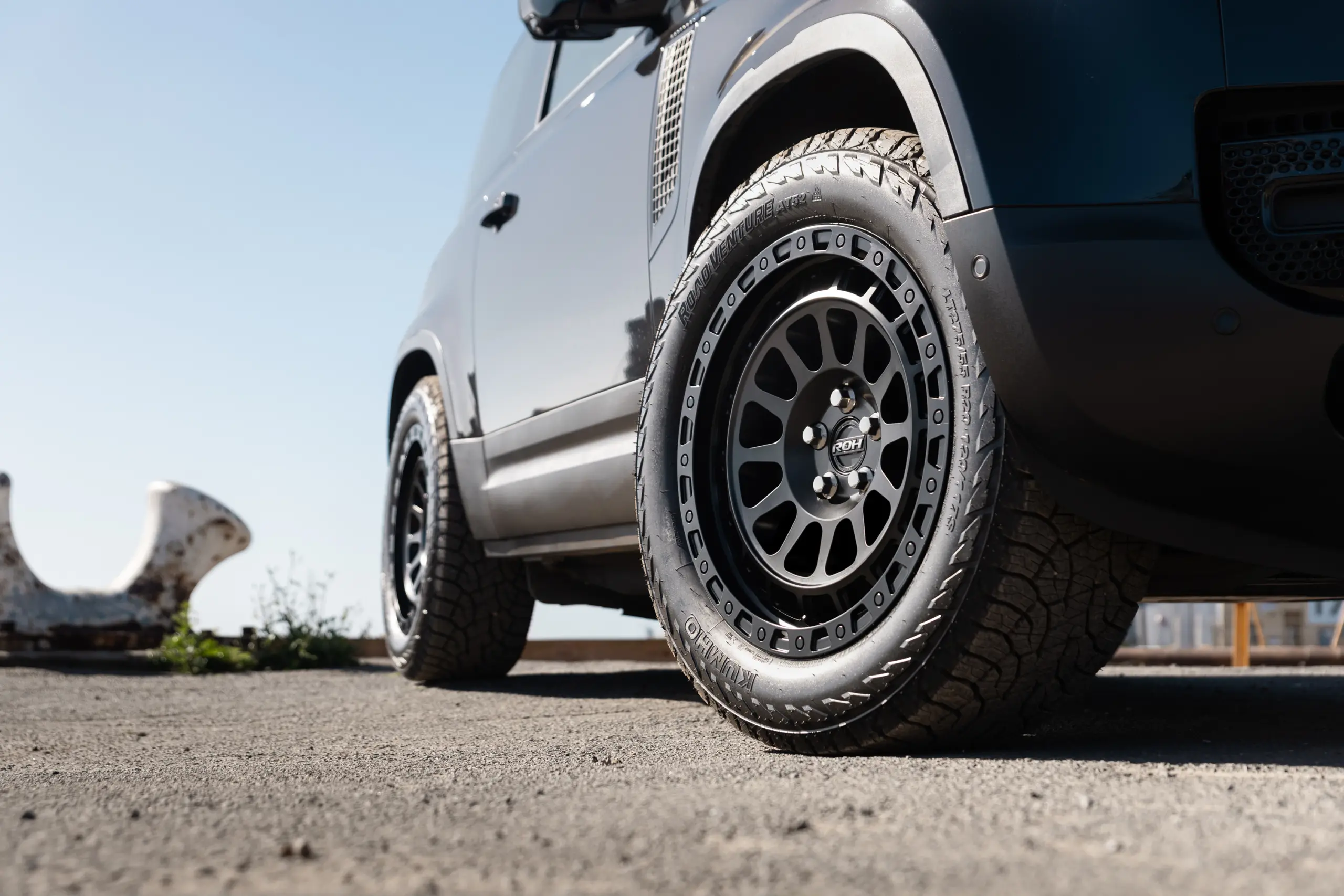 Black Land Rover Defender 90 with 20x9 +22 5x120 Matte Black ROH Assault Wheels at dockyard