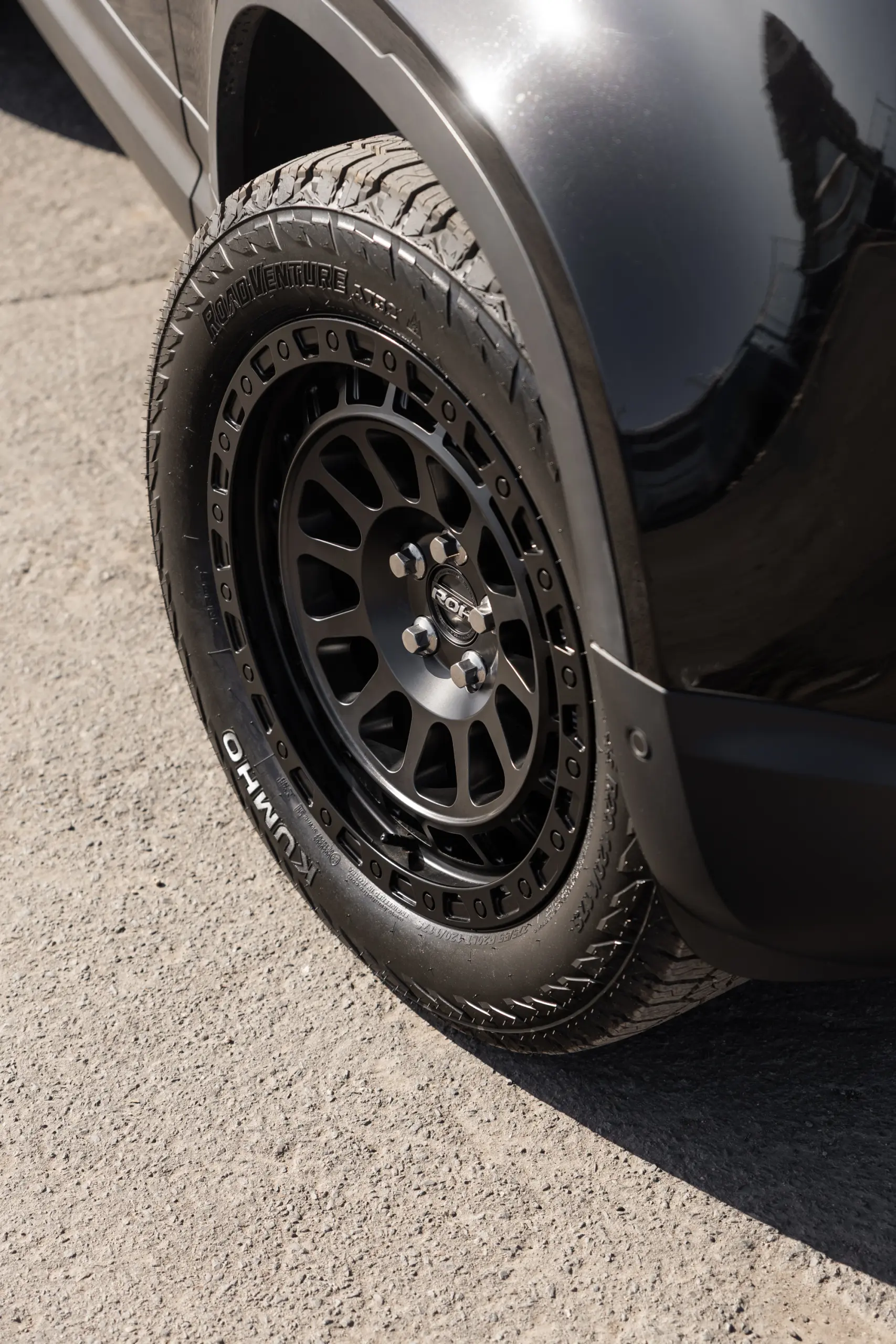 Black Land Rover Defender 90 with 20x9 +22 5x120 Matte Black ROH Assault Wheels at dockyard