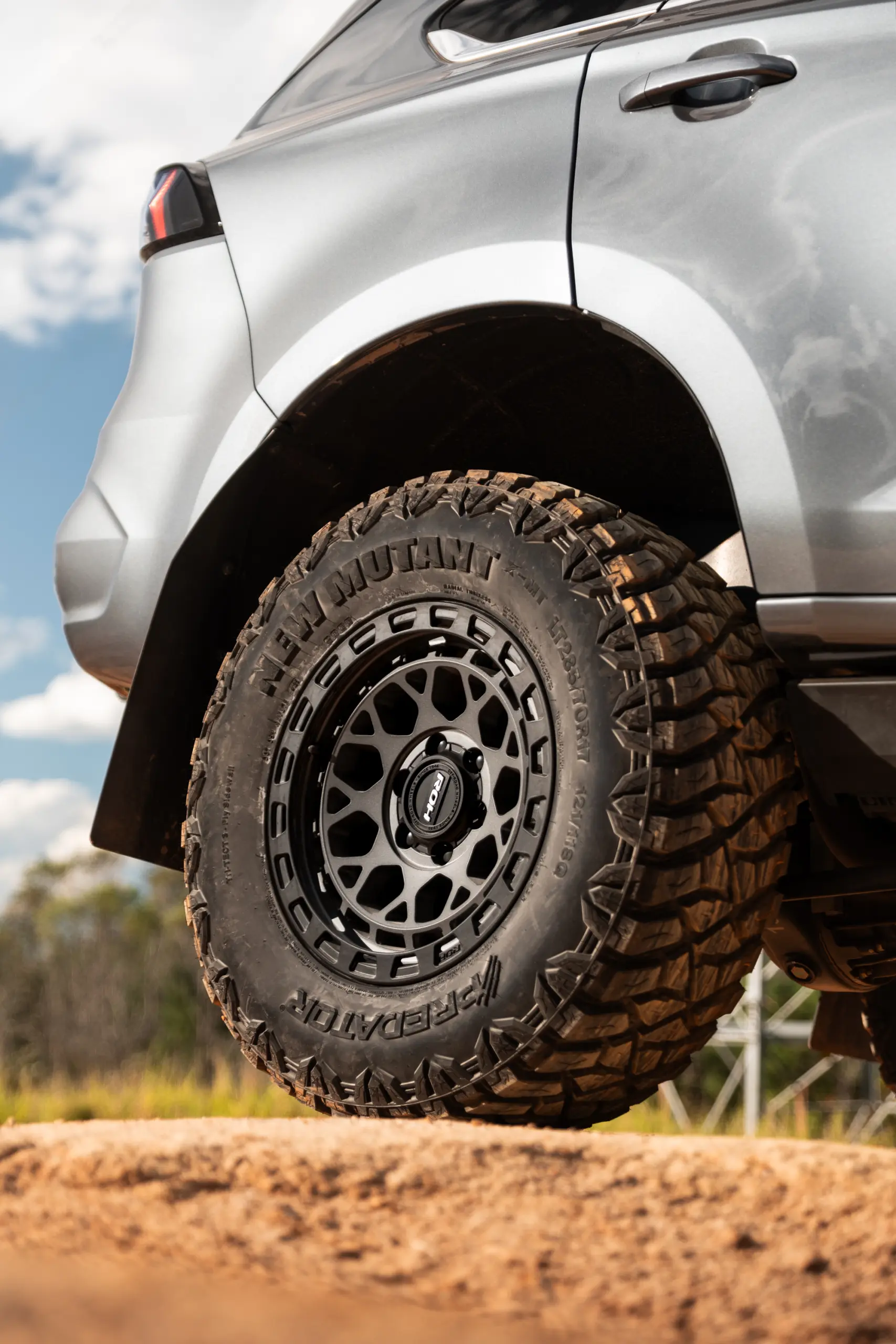 Grey Isuzu MU-X with ROH Atlas 4x4 Wheel in Graphite Centre Black Lip finish off road