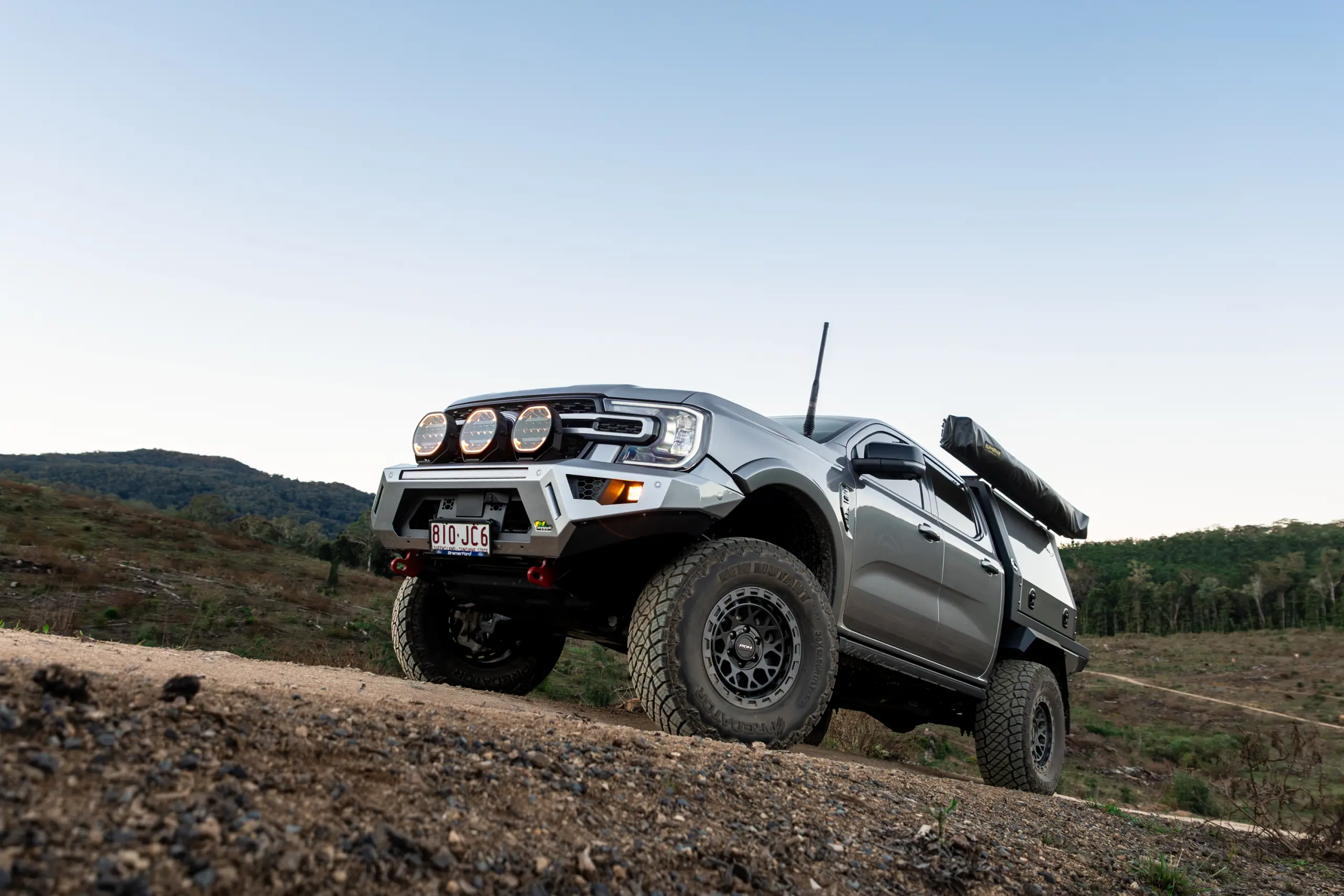 Silver Ford Ranger Next-Gen with 17x9 +12 ROH Atlas 4x4 Wheel in Black Centre Graphite Lip finish in forest