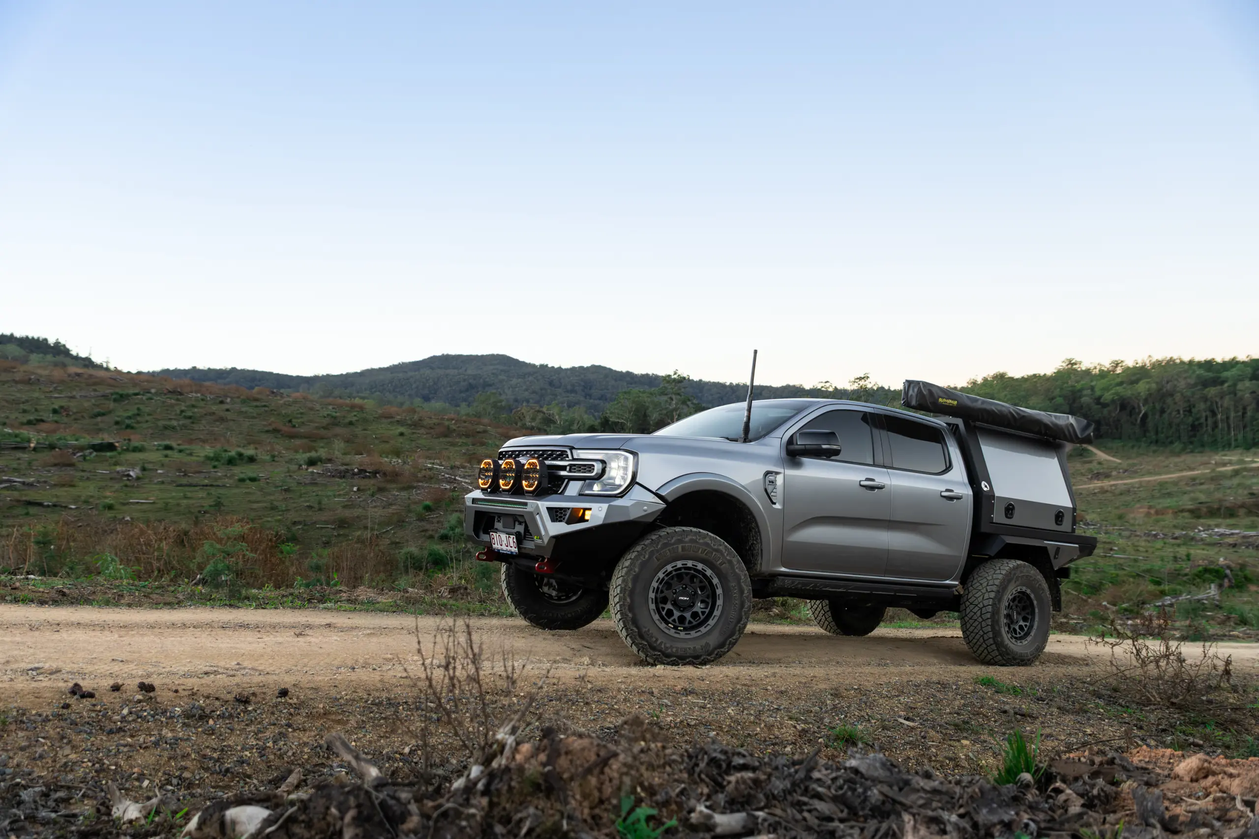 Silver Ford Ranger Next-Gen with 17x9 +12 ROH Atlas 4x4 Wheel in Black Centre Graphite Lip finish in forest