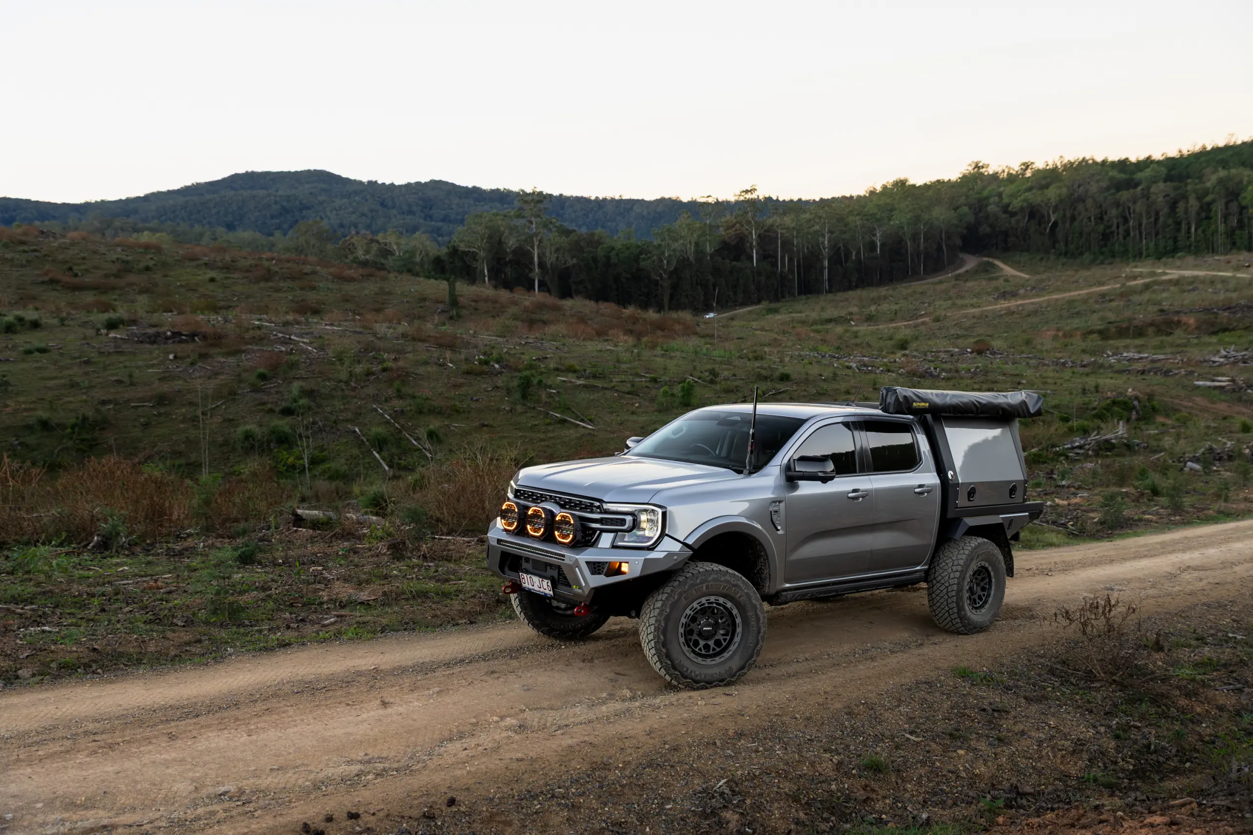 Silver Ford Ranger Next-Gen with 17x9 +12 ROH Atlas 4x4 Wheel in Black Centre Graphite Lip finish in forest