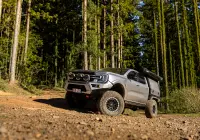 Silver Ford Ranger Next-Gen with 17x9 +12 ROH Atlas 4x4 Wheel in Black Centre Graphite Lip finish in forest