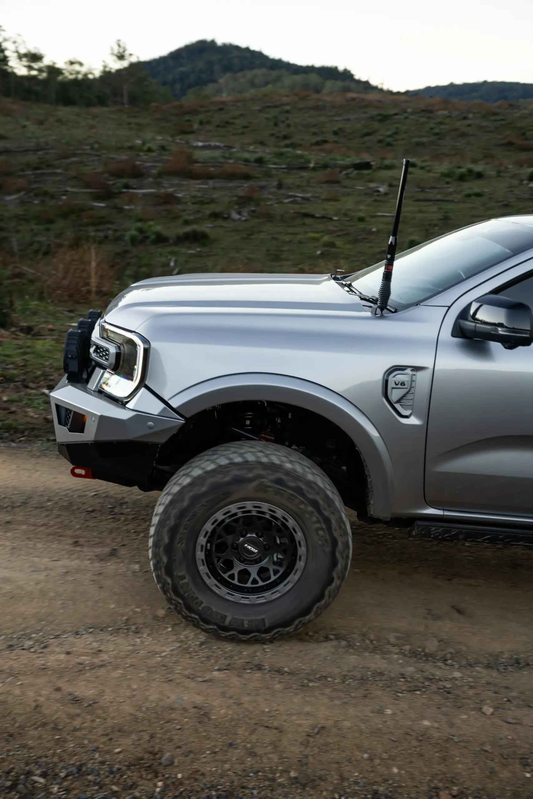 Silver Ford Ranger Next-Gen with 17x9 +12 ROH Atlas 4x4 Wheel in Black Centre Graphite Lip finish in forest