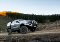 Silver Ford Ranger Next-Gen with 17x9 +12 ROH Atlas 4x4 Wheel in Matte Black in forest