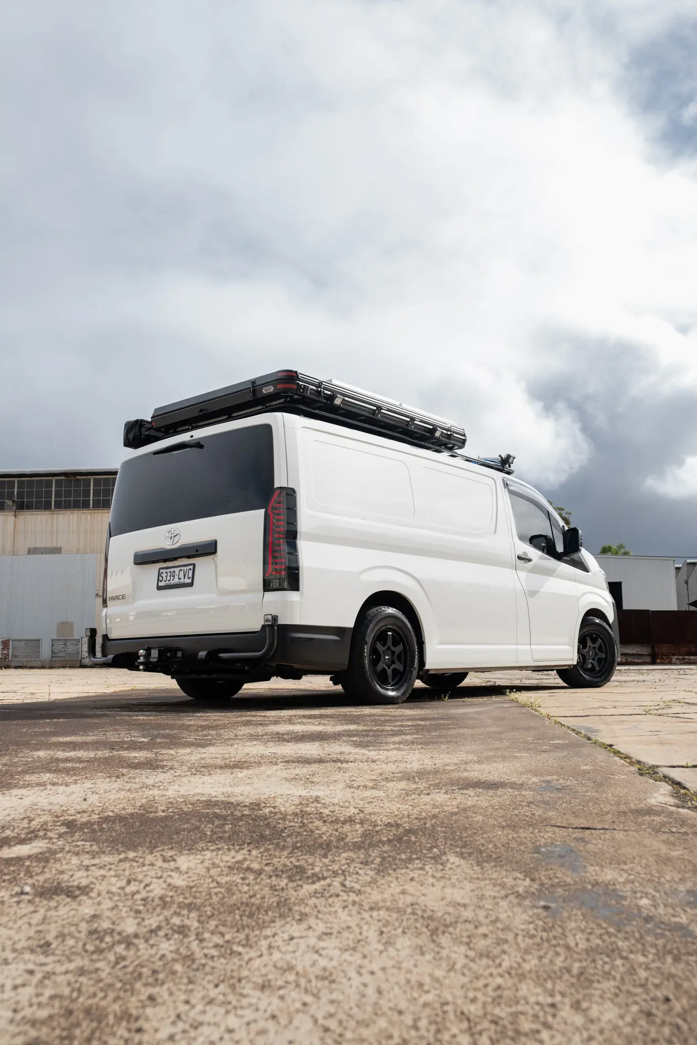 Toyota HiAce H300 Van with ROH Torque Matte Black Wheels in industrial area