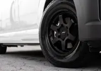 Toyota HiAce H300 Van with ROH Torque Matte Black Wheels in industrial area