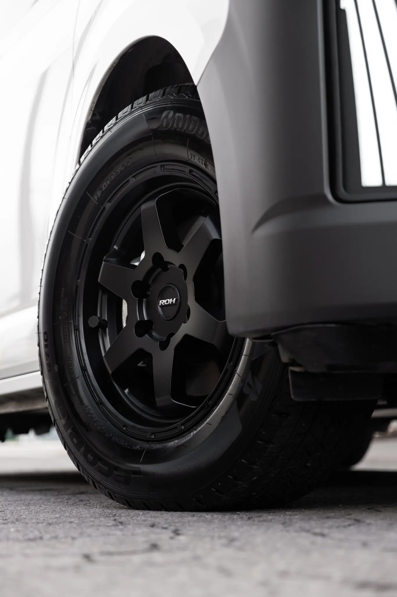 Toyota HiAce H300 Van with ROH Torque Matte Black Wheels in industrial area