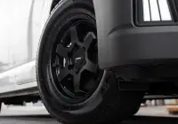 Toyota HiAce H300 Van with ROH Torque Matte Black Wheels in industrial area