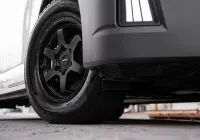 Toyota HiAce H300 Van with ROH Torque Matte Black Wheels in industrial area