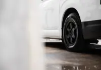 Toyota HiAce H300 Van with ROH Torque Matte Black Wheels in industrial area