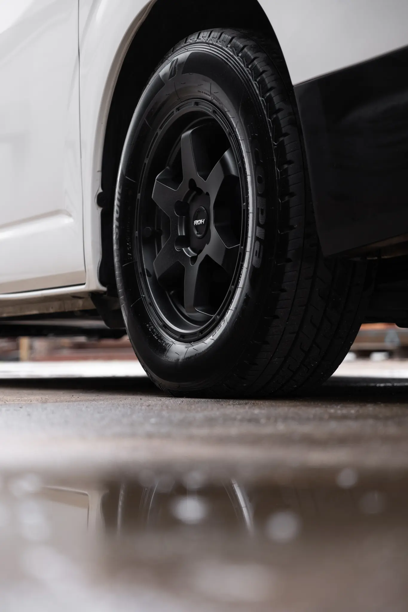 Toyota HiAce H300 Van with ROH Torque Matte Black Wheels in industrial area