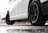 Toyota HiAce H300 Van with ROH Torque Matte Black Wheels in industrial area