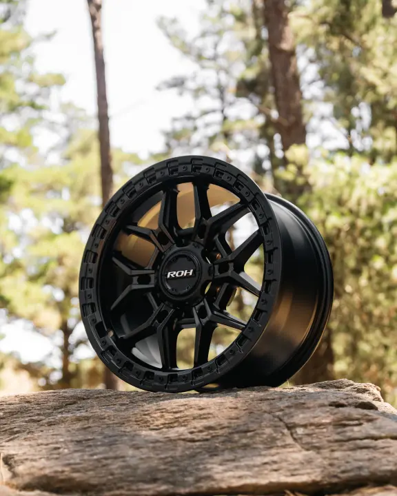 ROH Axe Matte Black 4x4 Alloy Wheel on forest rocks