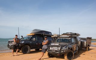 Jase and Simon from All 4 Adventure on beach in front of their vehicles