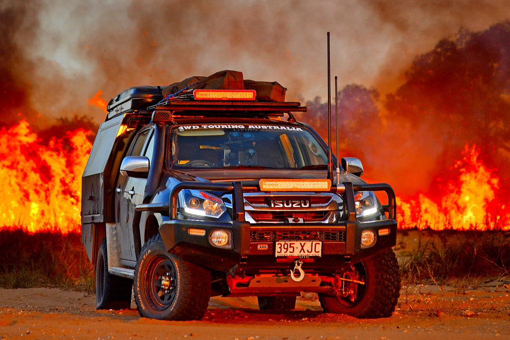 Black Steel wheels 4WD Touring Isuzu Fire smoke background