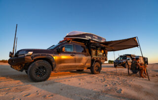 All 4 Adventure LandCruiser 200 Series with ROH Vapour wheels on the beach at sunset with Jase and Simon