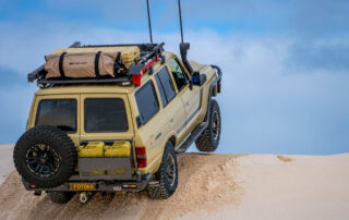 ROH Vapour wheels on Sandy 60 Series LandCruiser on the beach getting airborne