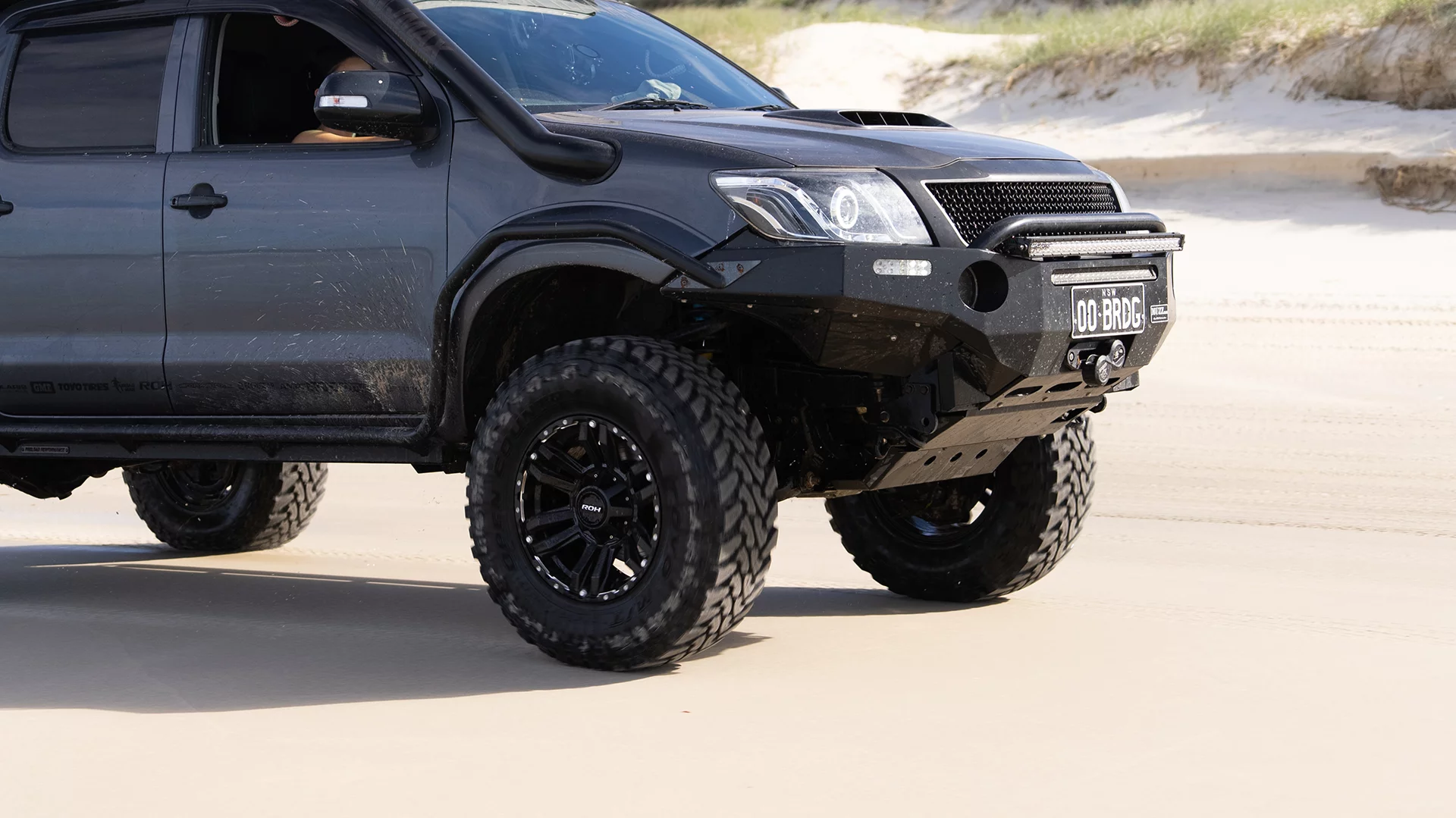 Bridget Red Dirt Diary Hilux rolling on beach with ROH Vapour wheels