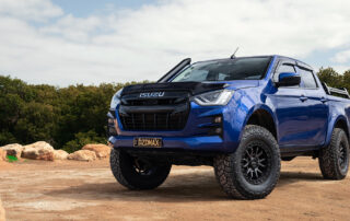 Raid wheels on blue hero Isuzu D-Max in front of rocks with mangroves
