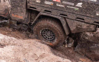 All 4 Adventure DMAX on Assault wheels on rocky muddy track